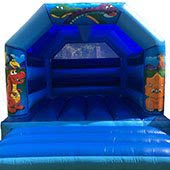 a blue Dinosaurs themed Bouncy Castle for hire.