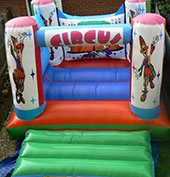 a Circus themed Bouncy Castle clowns on it.